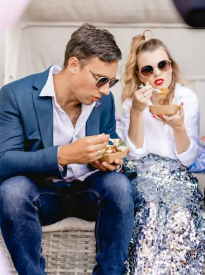 Couple enjoying food from a local vendor
