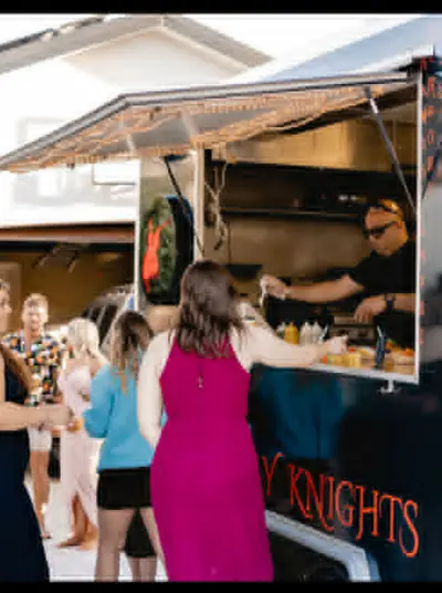 Customers ordering from a local food truck