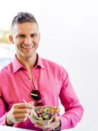 Customer enjoying food from a local food truck