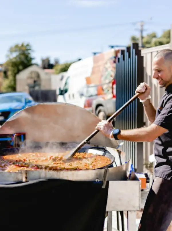 Fresh paella cooking at an outdoor food event